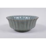 A Chinese celadon crackle glazed porcelain bowl of ribbed form, with flared rim, AF chip to rim,