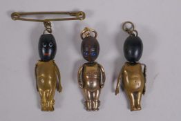 Three gilt metal Fumsup touch wud charms, 3cm long