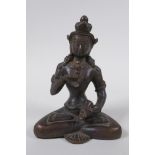 An antique Tibetan bronze figure of Buddha holding a vajra and bell, 16cm high