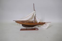 A wood model of a sailing yacht, with canvas sails, AF mast broken but appears all complete, hull