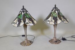 A pair of Tiffany style table lamps, with metal bases and glass shades, 55cm high