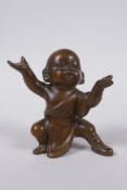 An oriental bronze figure of a child monk, 8cm high