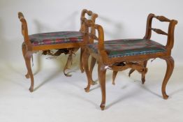 A pair of walnut stools/window seats with carved decoration, raised on cabriole supports, 66 x 43