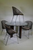 A John Lewis dining table with faux leather base and glass top, and four cane tub chairs with faux