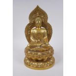 A Sino Tibetan gilt metal figure of Buddha seated on a lotus flower, impressed 4 character mark to