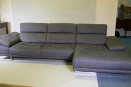 A Natuzzi corner sofa in two sections, with adjustable arms and backs, and textile upholstery, 316 x