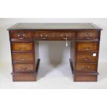 A Victorian style mahogany eight drawer pedestal desk, with leather inset top, raised on a plinth,