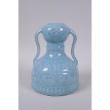 A celadon glazed porcelain two handled garlic head shaped vase with stylised under glaze dragon