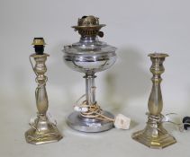 A pair of silver plate candlesticks converted to table lamps, 26cm high, and a similar oil lamp