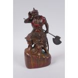 A Sino Tibetan painted and gilt bronze figure of a warrior with an axe, impressed 4 character mark