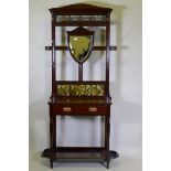 A Victorian mahogany wall stand with shield shaped mirror, tiled back and single drawer, 92 x 205cm