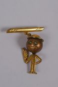 A gilt metal Fumsup pendant brooch with glass eyes and tommy helmet, marked 01 to back, Reg No.