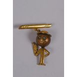 A gilt metal Fumsup pendant brooch with glass eyes and tommy helmet, marked 01 to back, Reg No.