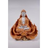 A Chinese orange glazed porcelain figure of Buddha seated within a lotus flower, impressed marks