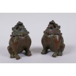 A pair of Japanese censers and covers in the form of temple lions, marks to base, 7cm high