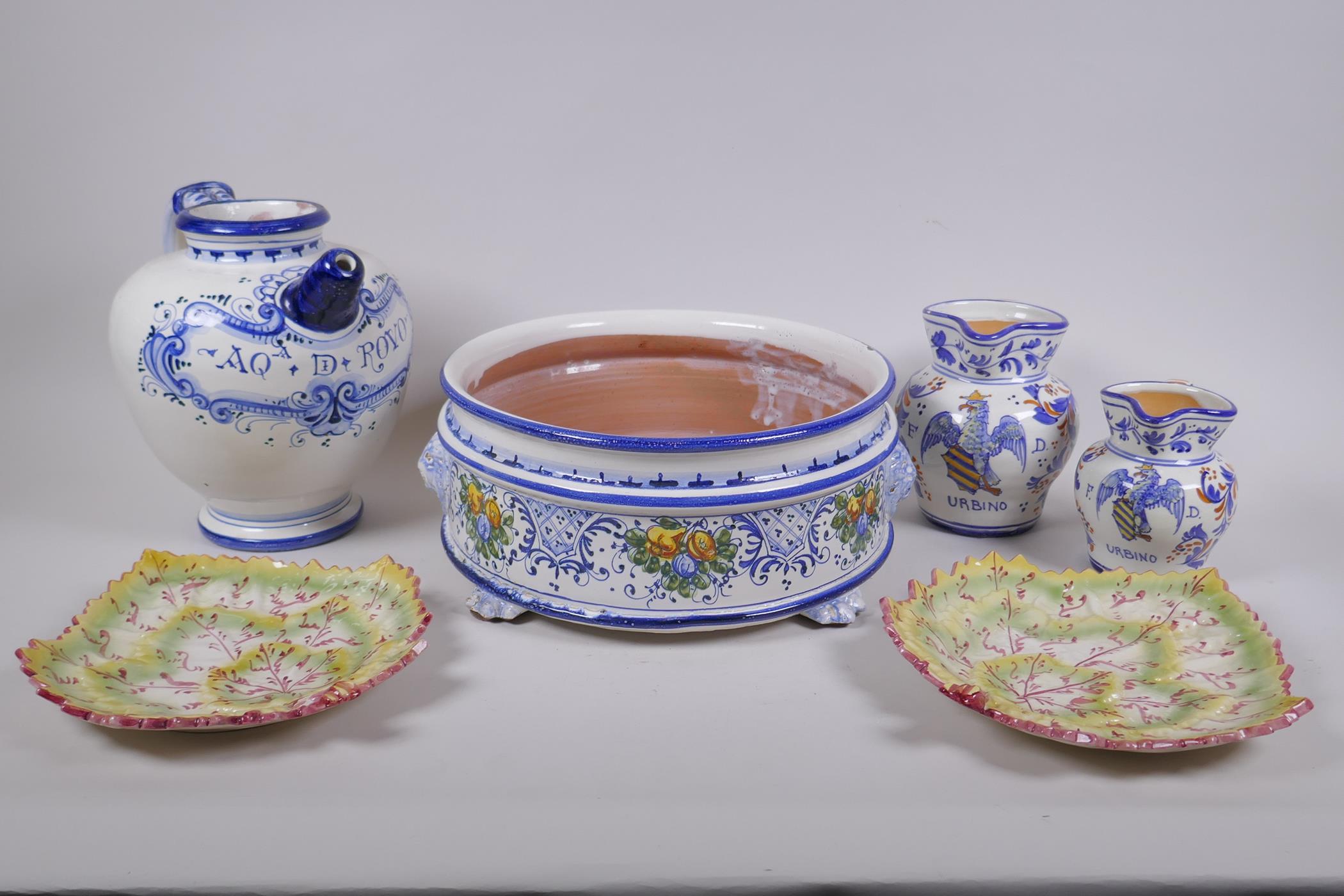 A collection of Italian majolica to include a bramble wine jug, leaf, shape dishes, a steep sided