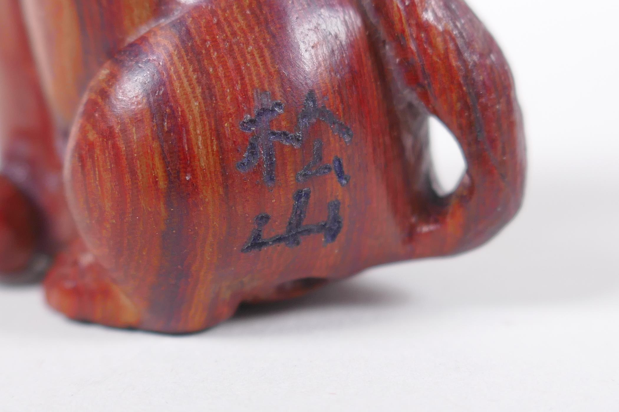 A Japanese carved wood netsuke in the form of a dog, signed, 5cm high - Image 3 of 3