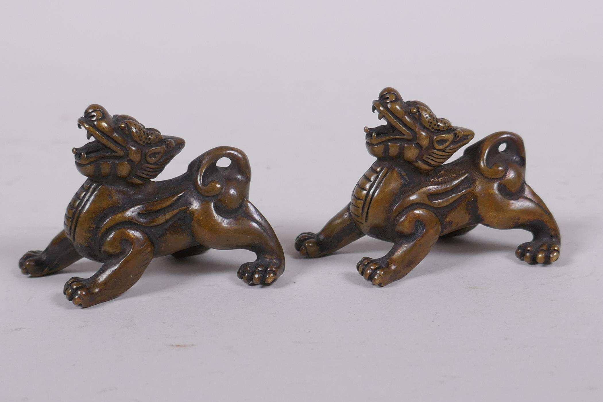 A pair of Chinese bronze kylin scroll weights, 5cm long - Image 2 of 4