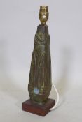 A bronze table lamp with oriental inspired raised decoration, mounted on a wood base, 32cm high