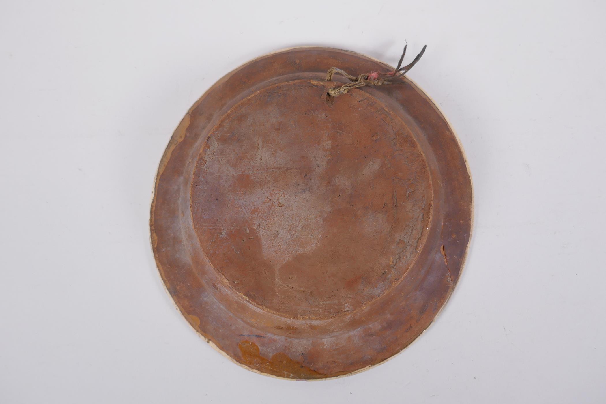 An antique Spanish terracotta dish with a faience glaze and floral decoration, AF repair, 21cm - Image 4 of 6