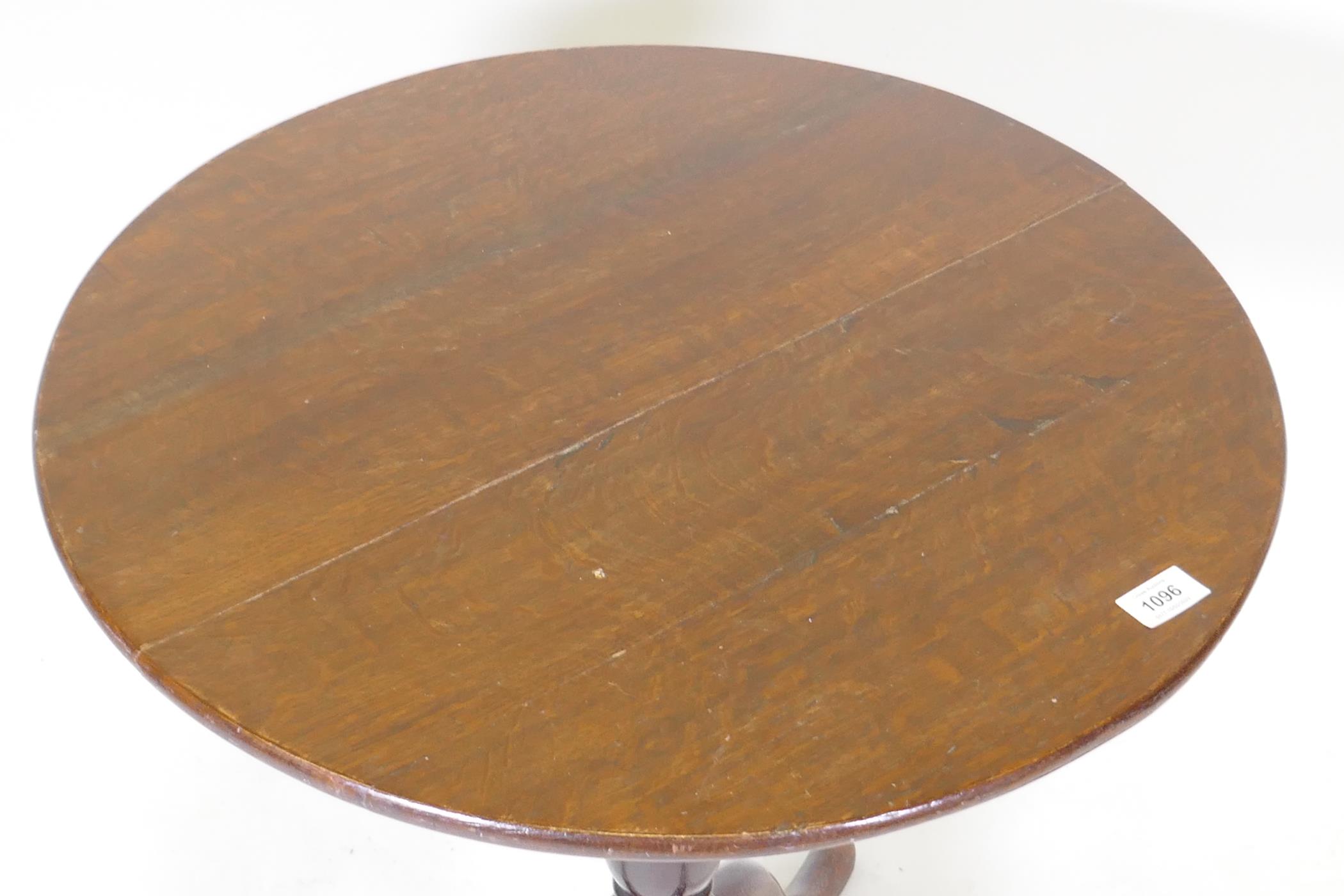 A Georgian tilt top oak table, raised on a canon barrel turned column with tripod supports, adapted, - Image 3 of 5