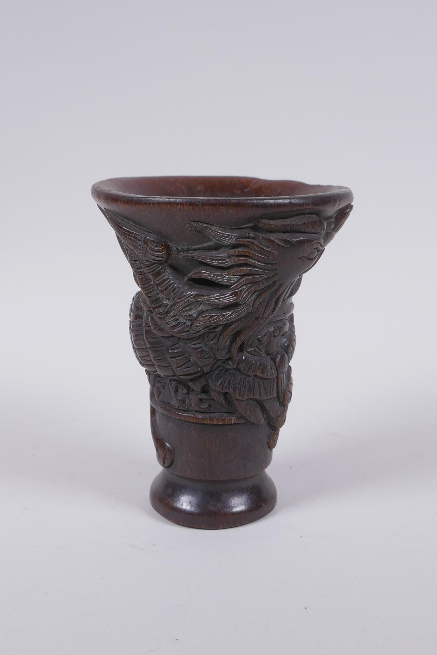 A Chinese faux horn libation cup with raised phoenix  decoration, 13cm high