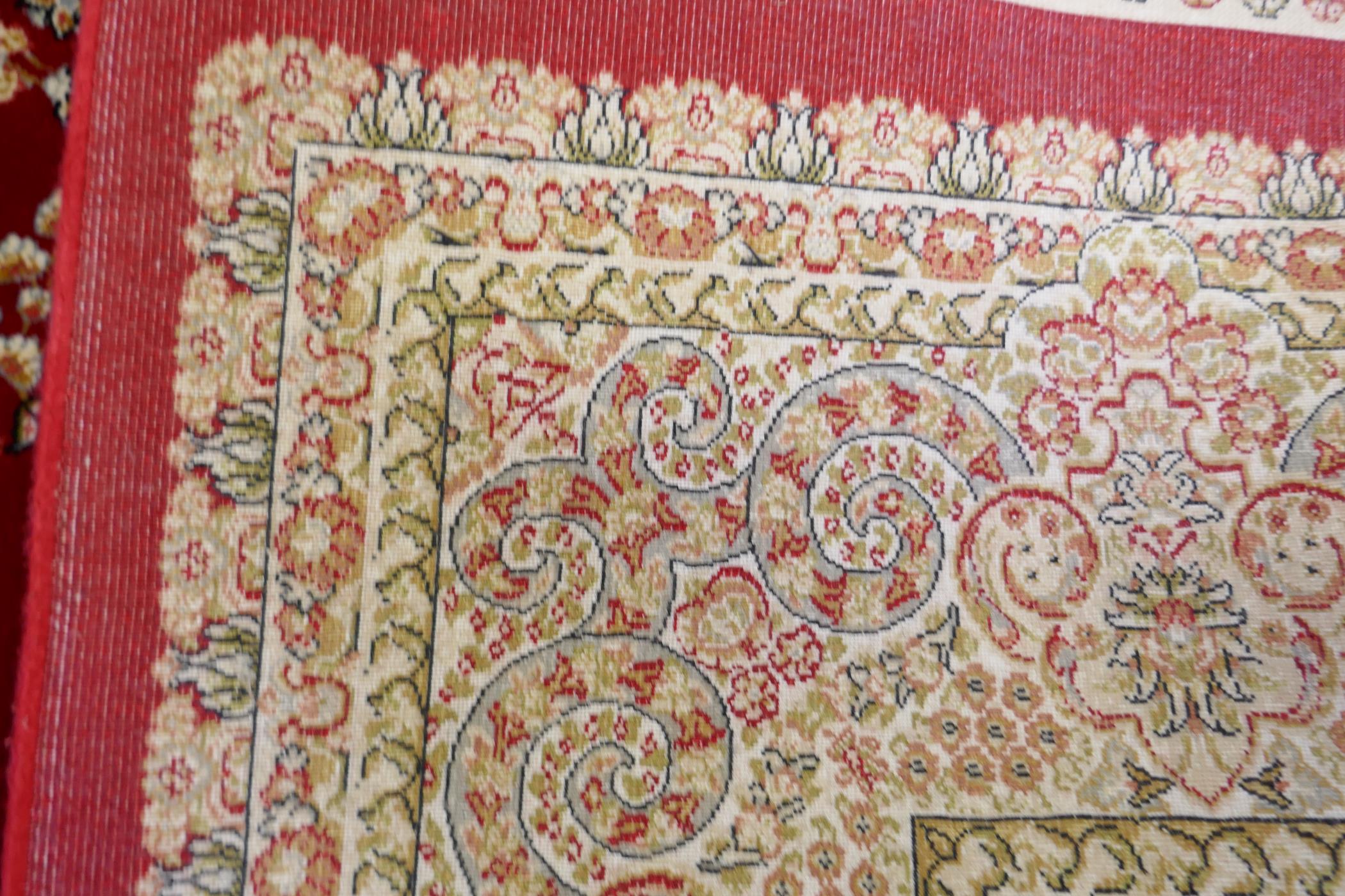 A rich ruby red ground full pile Qum rug with floral medallion pattern, 158 x 234cm - Image 5 of 7