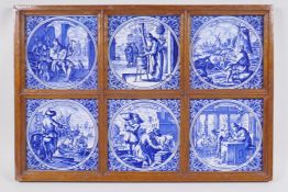 A framed set of six Dutch style blue and white tiles depicting various trades, 49 x 34cm