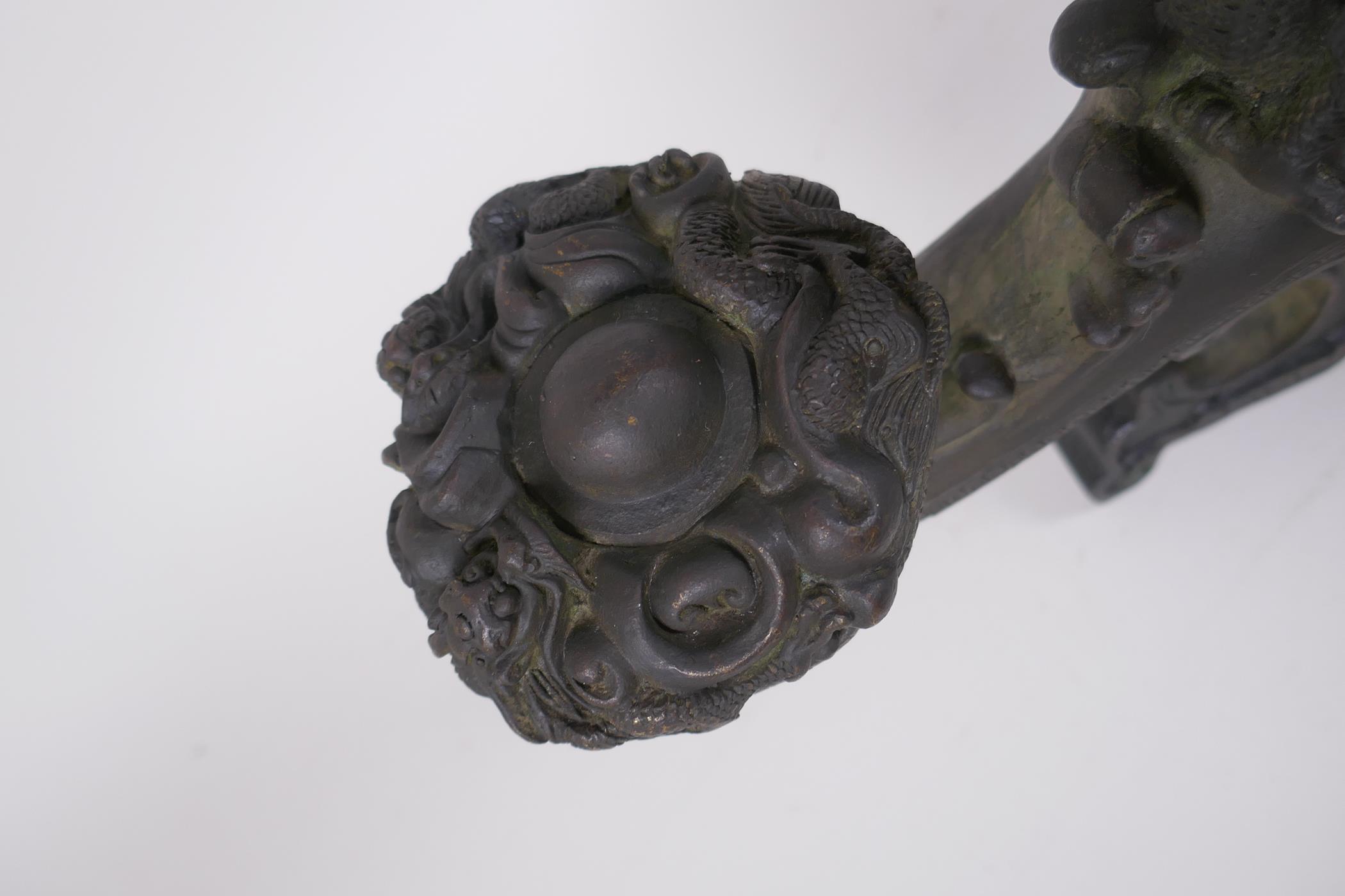A Chinese filled bronze ornament in the form of a ruyi surmounted by a dragon with a character - Image 5 of 8