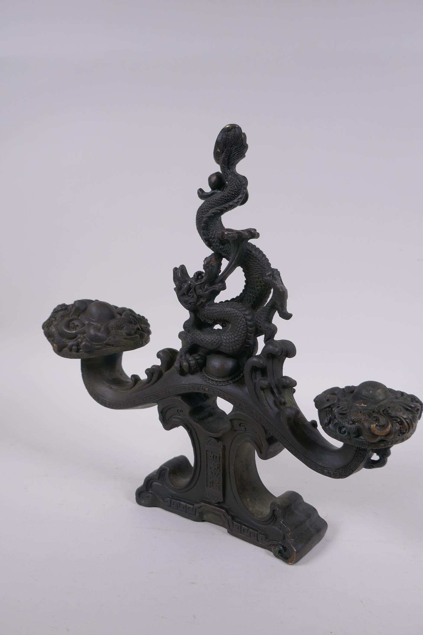 A Chinese filled bronze ornament in the form of a ruyi surmounted by a dragon with a character - Image 4 of 8