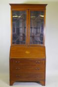 A Victorian mahogany bureau bookcase with a astral glazed top, the fall front fitted with pigeon