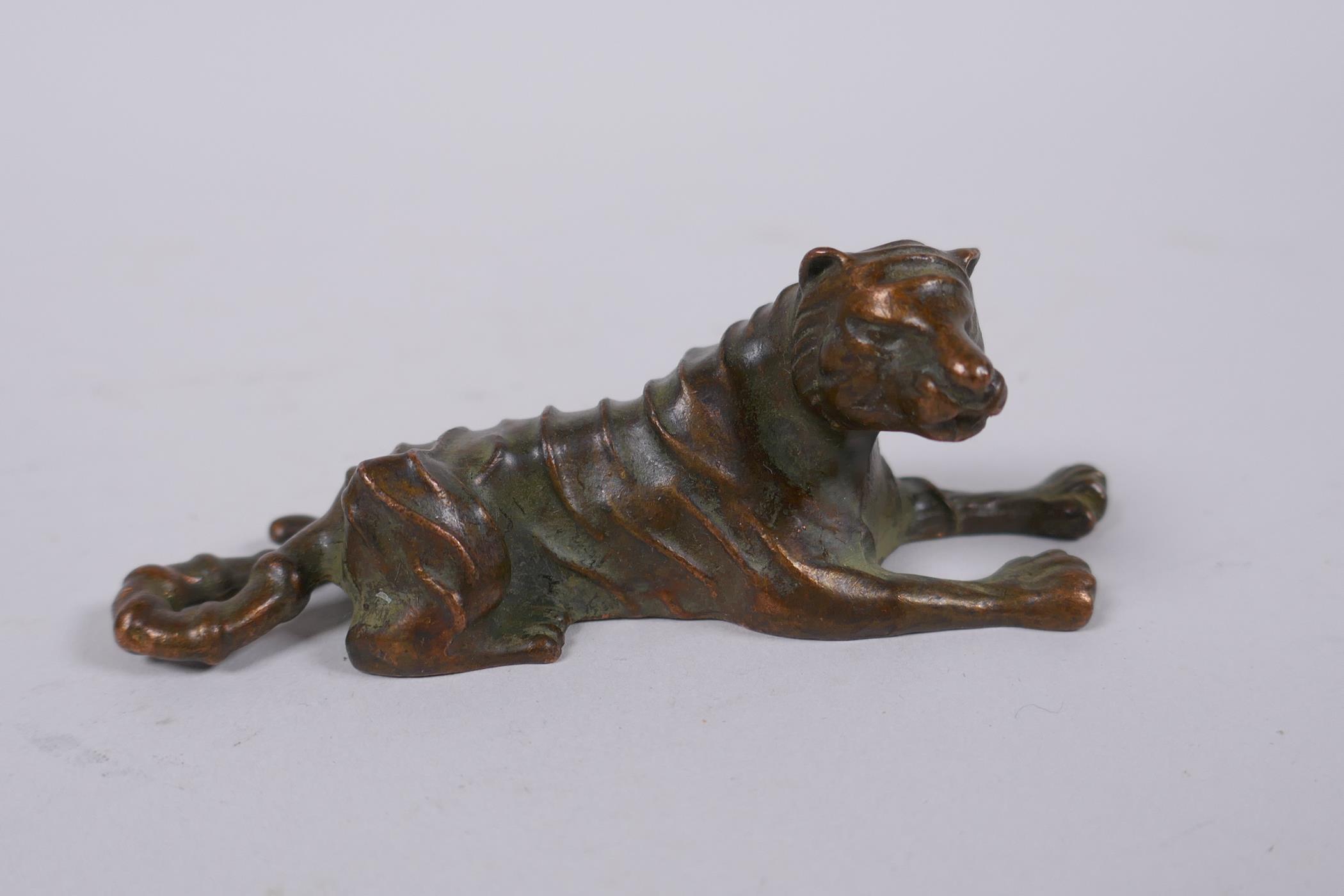 A Japanese bronze okimono tiger, mark to base, 9cm long