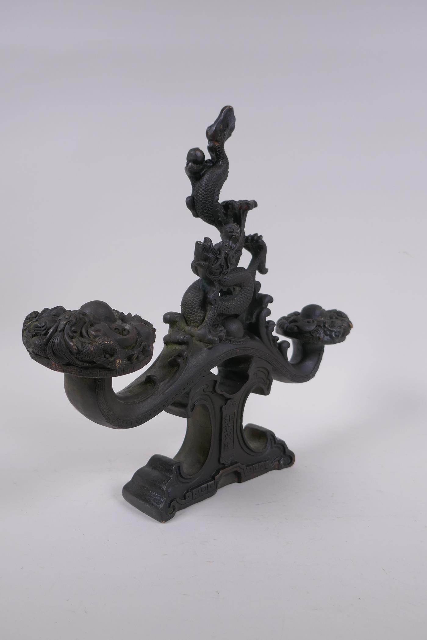 A Chinese filled bronze ornament in the form of a ruyi surmounted by a dragon with a character - Image 2 of 8