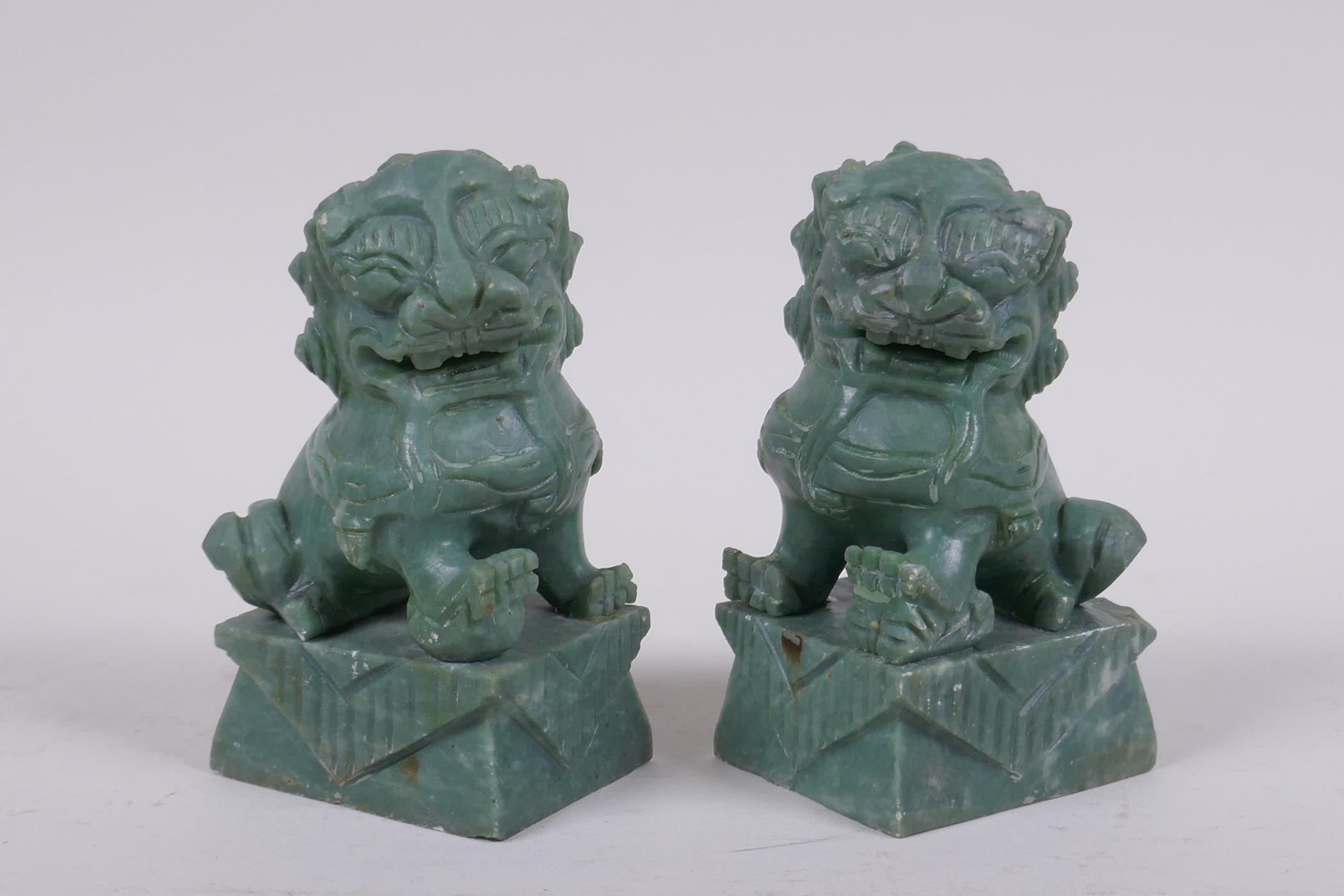 A pair of Chinese carved green soapstone temple lions, 10cm high