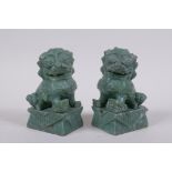 A pair of Chinese carved green soapstone temple lions, 10cm high