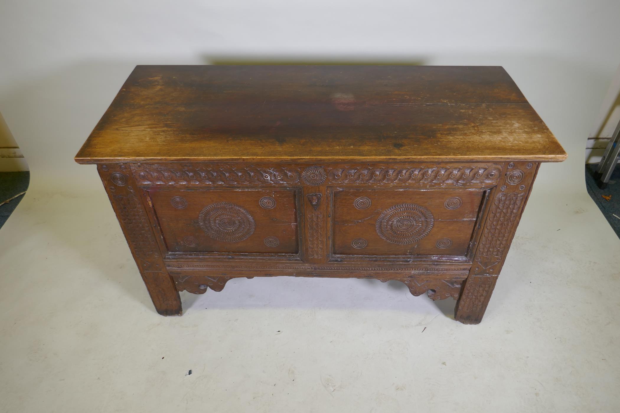 An C18th continental oak coffer, two panelled front with chip carved decoration under a sea scroll - Image 3 of 5