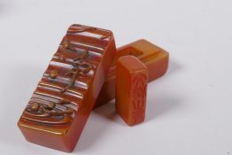 A Chinese amber soapstone box containing a seal, the cover with ripple decoration and character