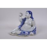 A Chinese blue and white porcelain reclining figure with a toad and coin, impressed seal mark to