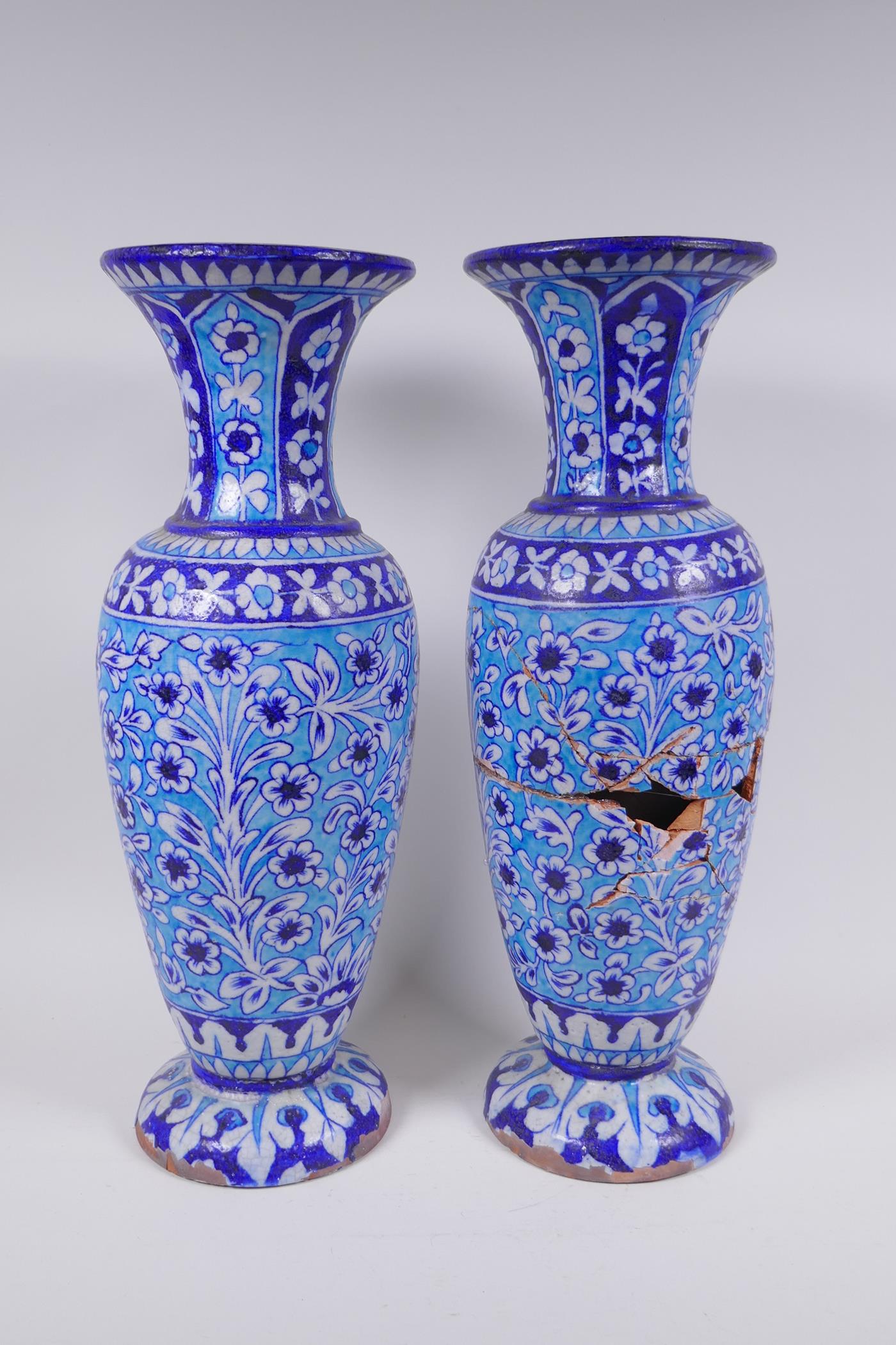 A pair of C19th Islamic Multan terracotta vases with blue Kashigari designs, AF, 46cm high