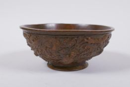 A Chinese bronze trinket bowl with raised dragon decoration, Qianlong 4 character mark to base, 11cm