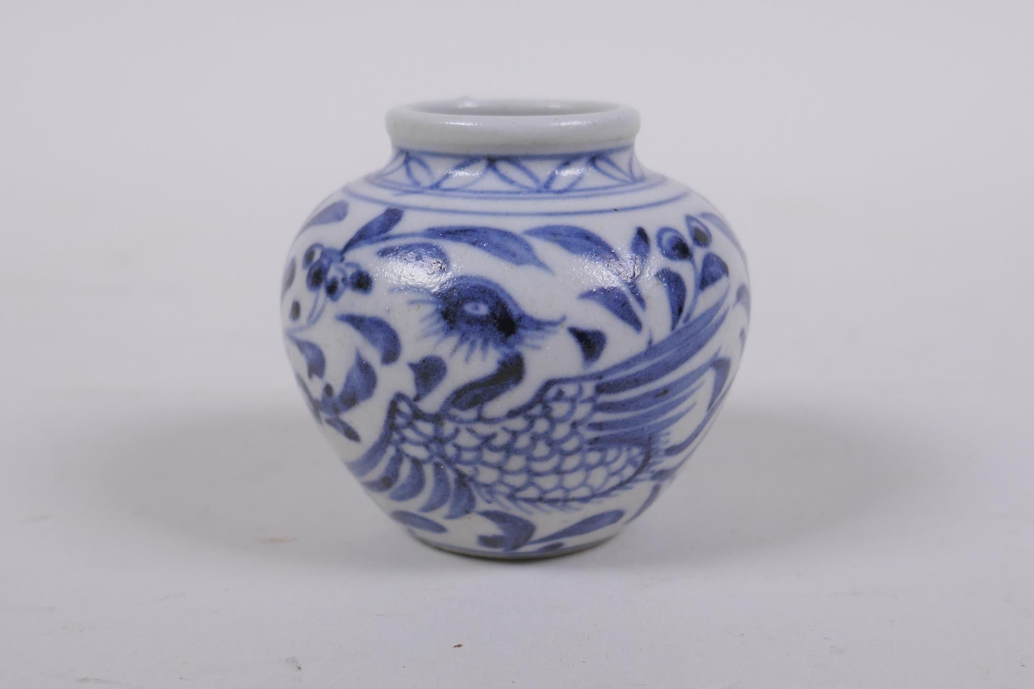 An early Chinese miniature blue and white porcelain pot with phoenix decoration, possibly Yuan