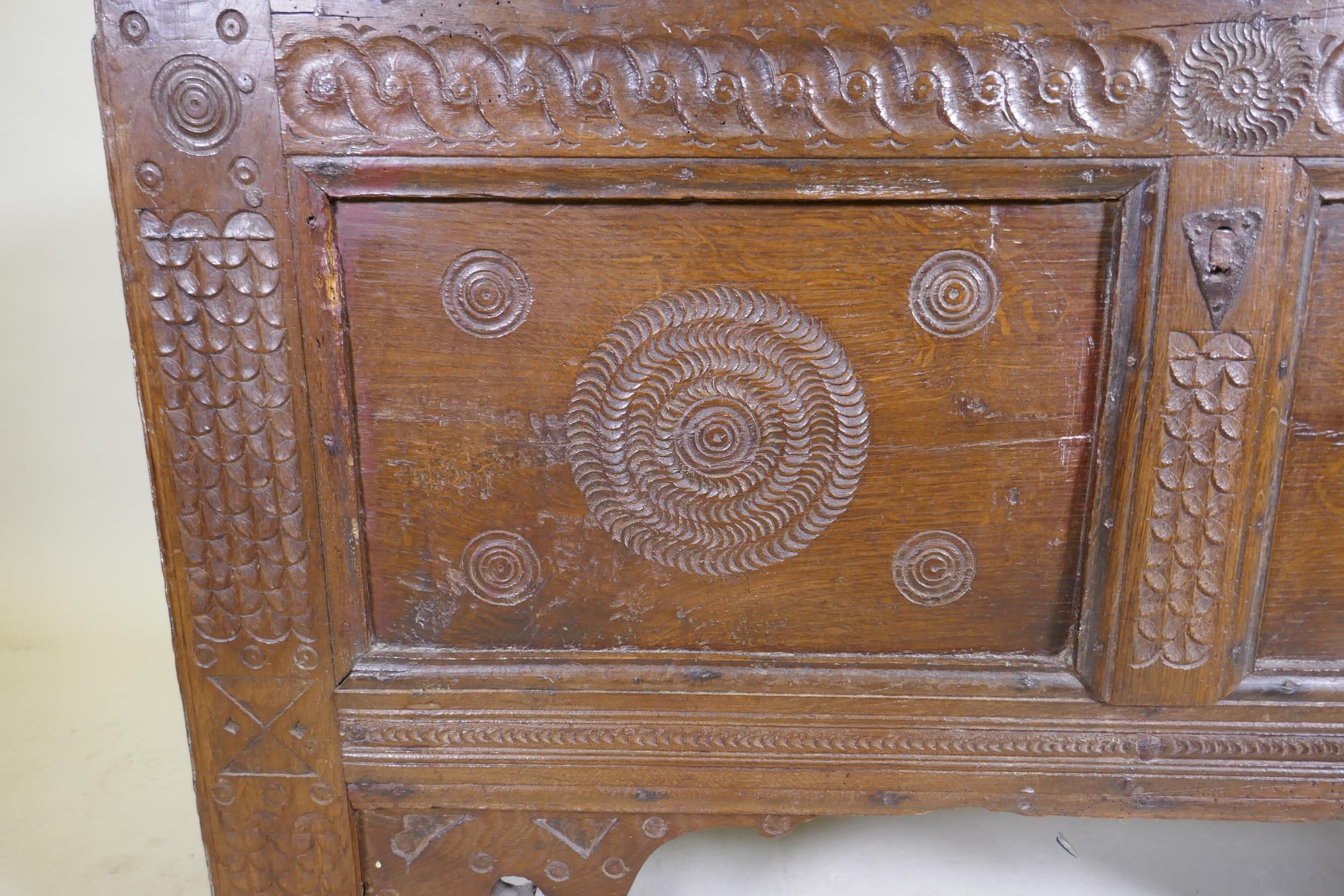 An C18th continental oak coffer, two panelled front with chip carved decoration under a sea scroll - Image 4 of 5