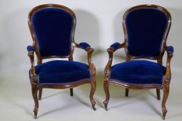 A pair of Victorian mahogany show frame arm chairs with faux bois grain painted decoration, raised