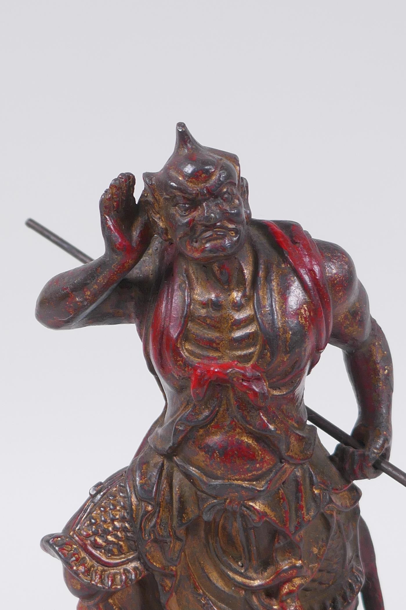 A Sino Tibetan painted and gilt bronze figure of a warrior with an axe, impressed 4 character mark - Image 2 of 5