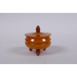 A faux butterscotch and honey amber pot and cover, 5cm diameter