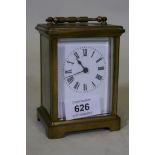 A brass cased glass carriage clock with enamel dial, 12cm high