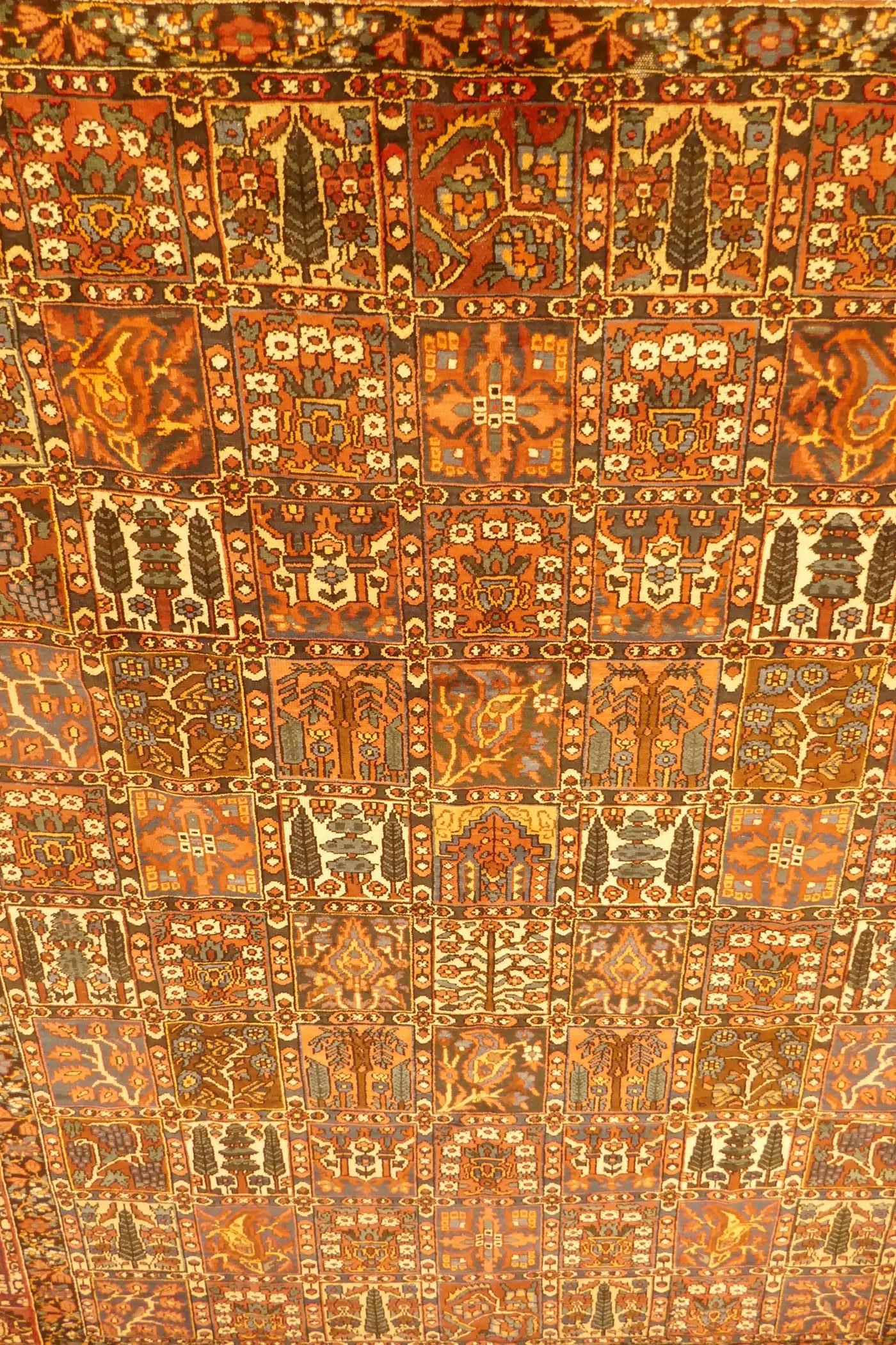 A Persian Bakhtiar multi-colour ground carpet, with Persian panel design, 335 x 250cm