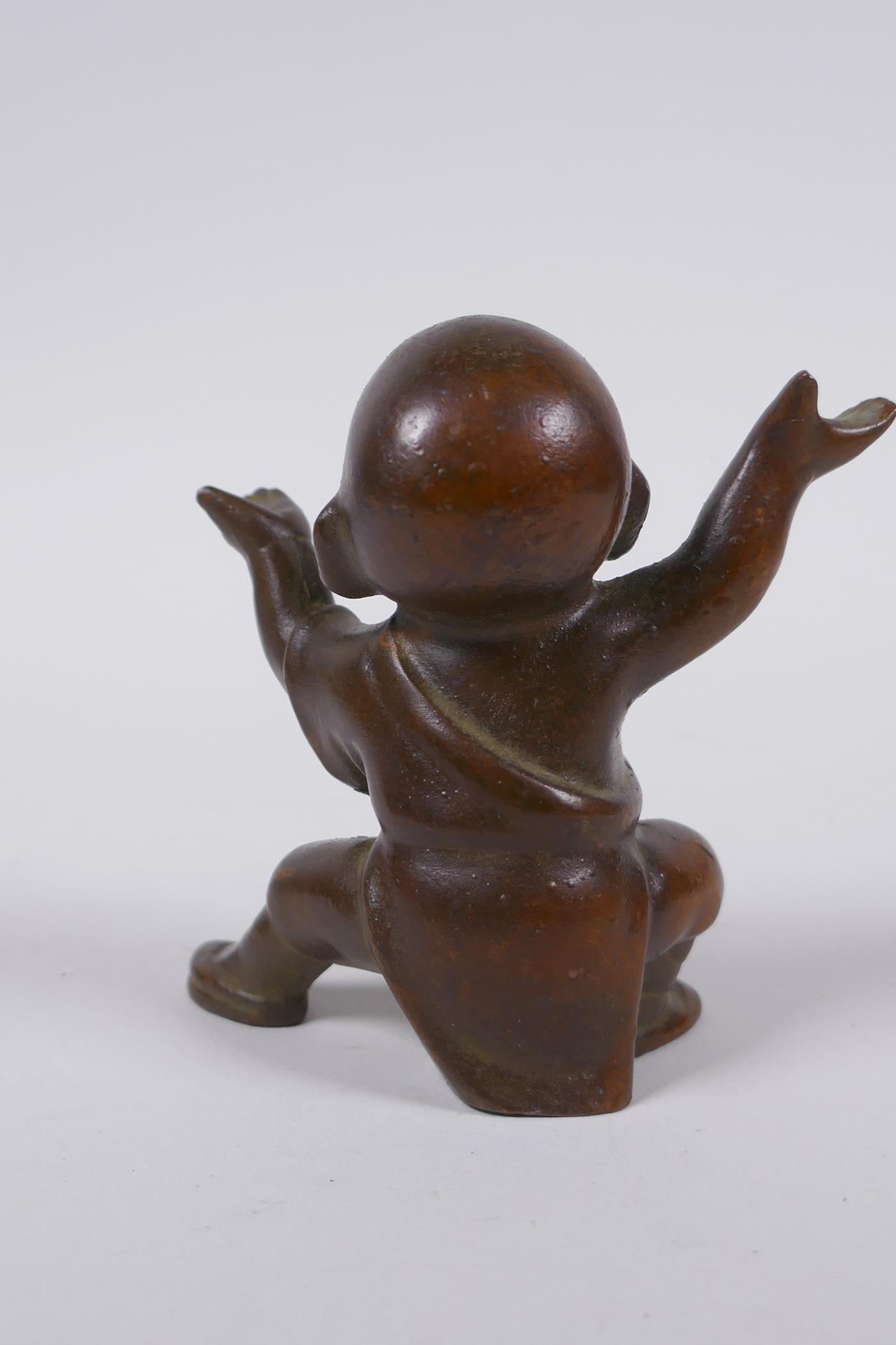 An oriental bronze figure of a child monk, 8cm high - Image 2 of 4