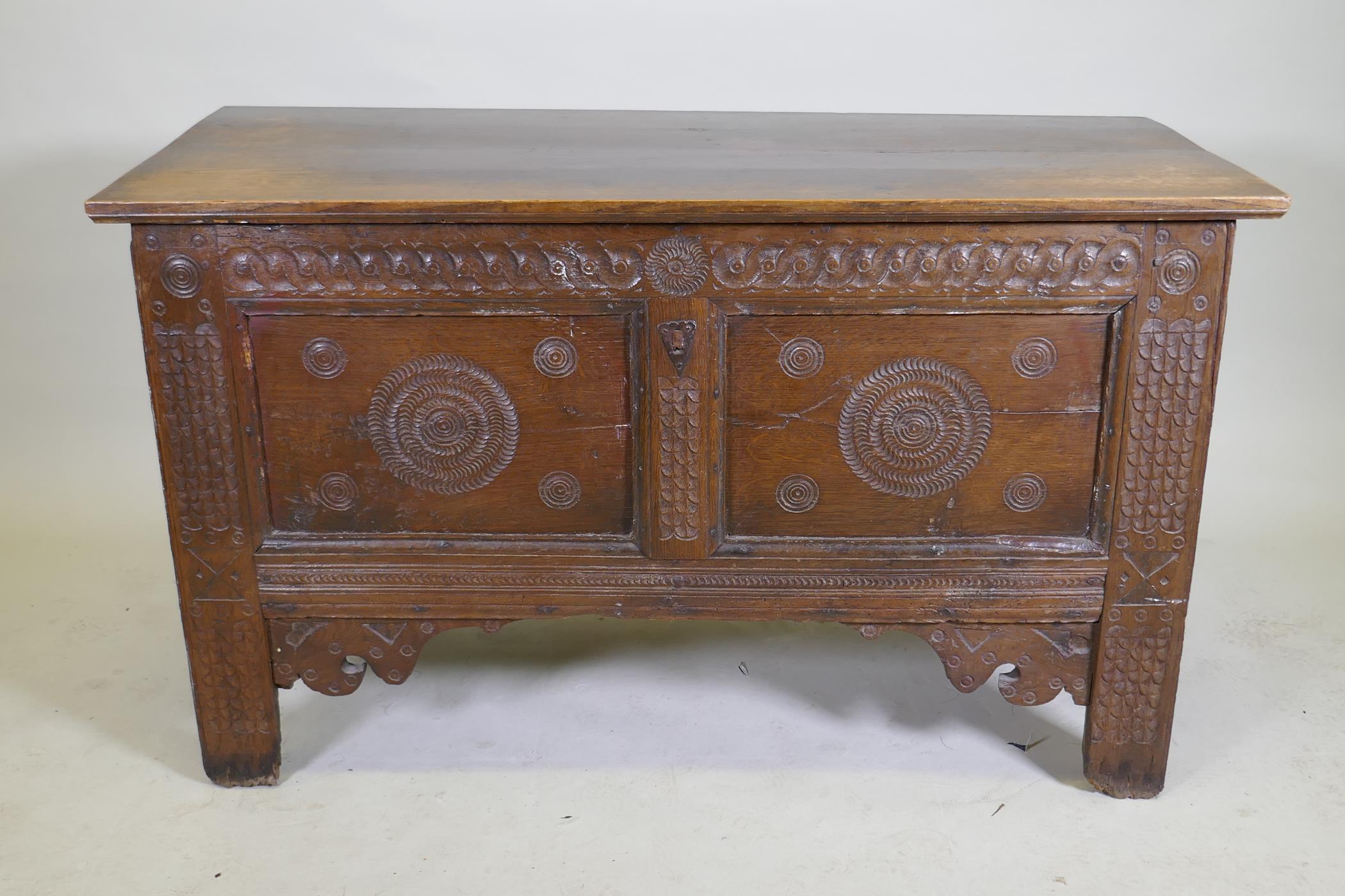 An C18th continental oak coffer, two panelled front with chip carved decoration under a sea scroll - Image 2 of 5