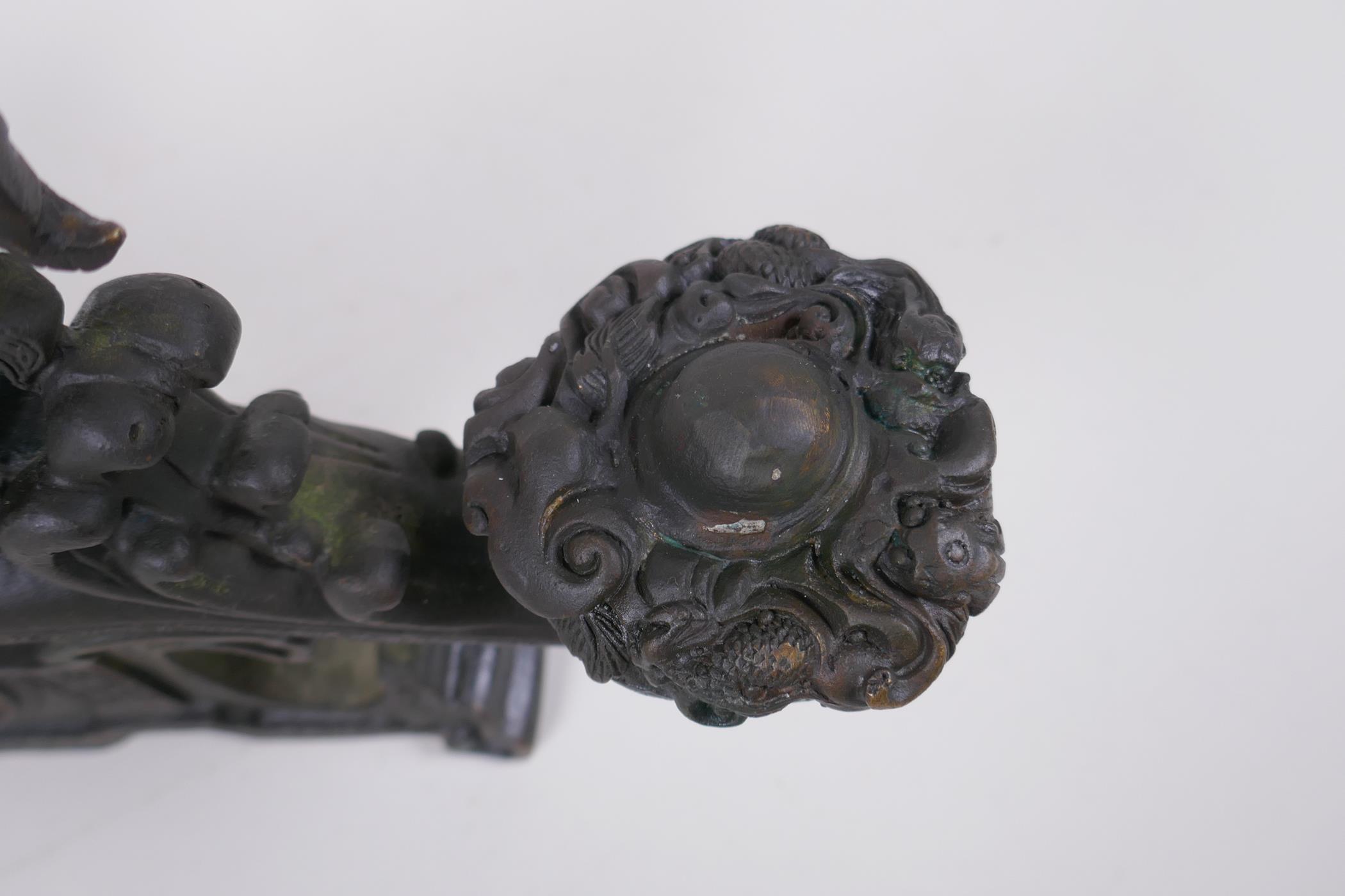 A Chinese filled bronze ornament in the form of a ruyi surmounted by a dragon with a character - Image 6 of 8